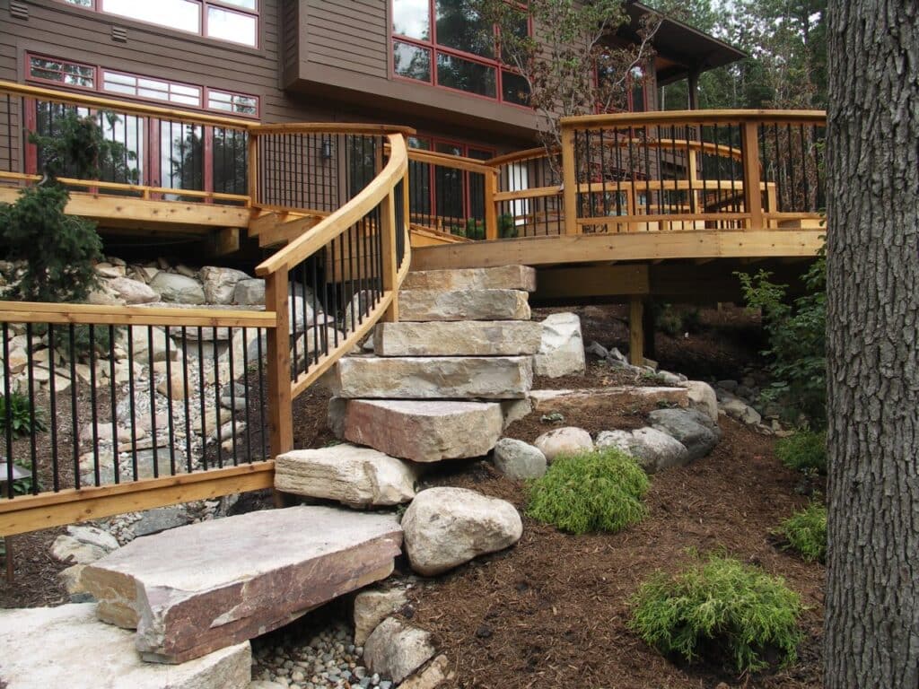 Precision is a deck builder in the greater Grand Rapids area. A deck design that incorporates stone landings and landscape.