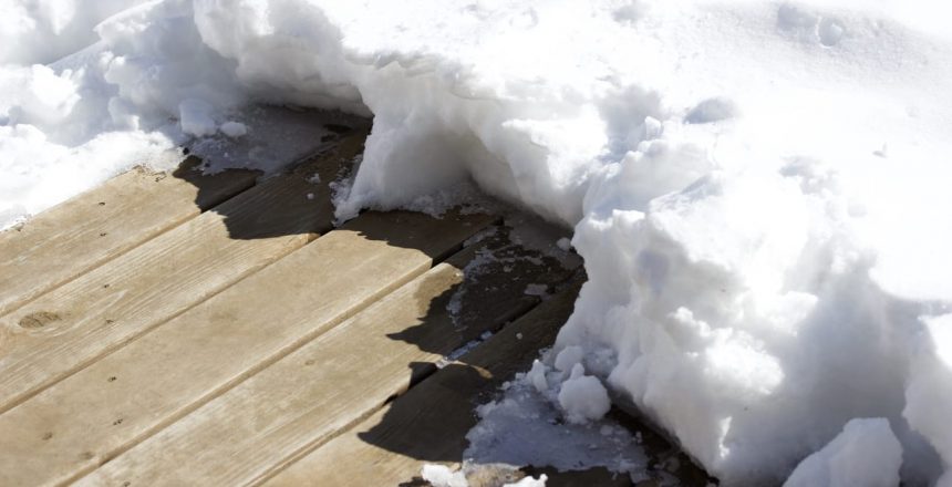 Winter deck protection can help your deck when the weather beats it up. A deck covered in 4 inches of snow.